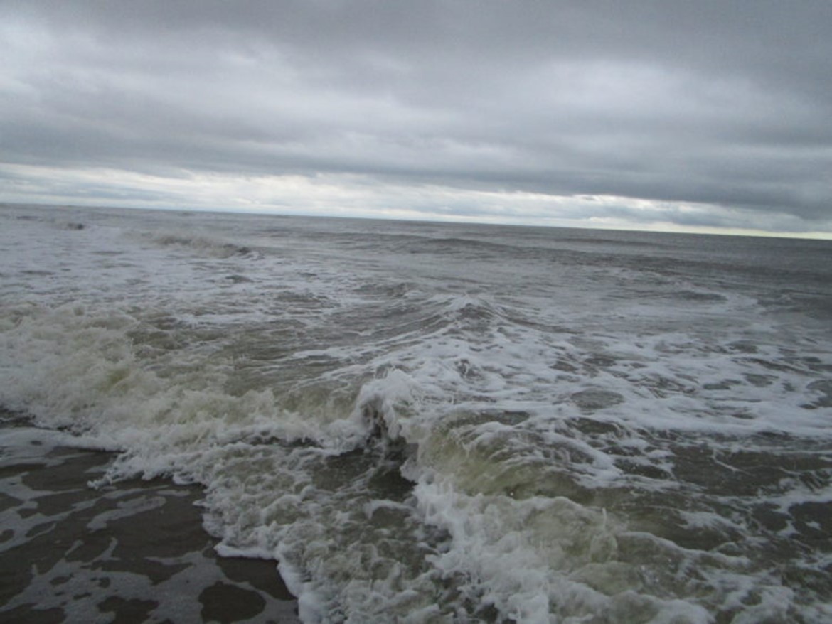 The Awakening cover image-Waves in the ocean with grey skies