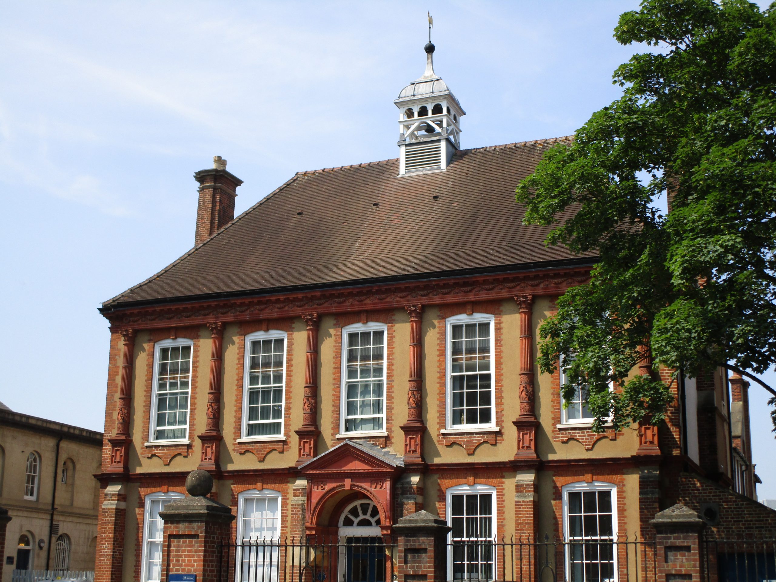 Pygmalion--picture of a large brown house